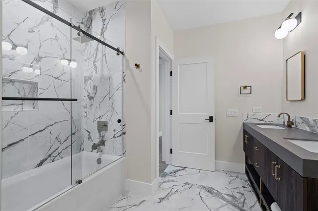 a bathroom with a tub sink and mirror