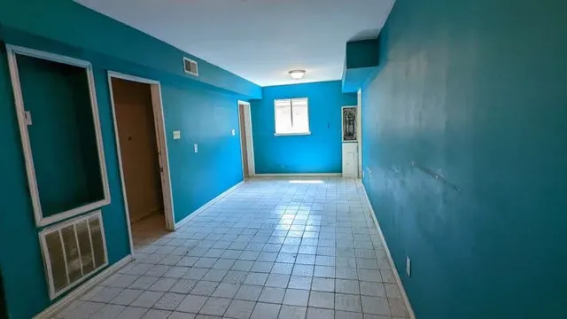 a view of an empty room with windows