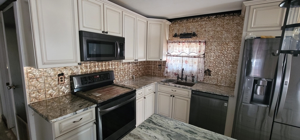 25 Windswept Road Wareham, MA 02571 - Photo 17 of 39 a kitchen with stainless steel appliances granite countertop a stove sink and refrigerator