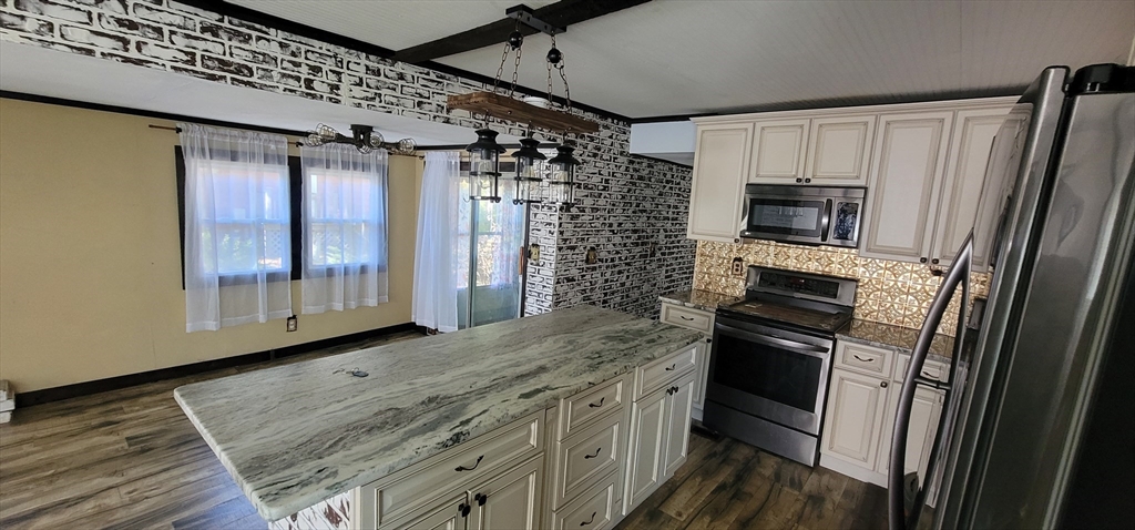 25 Windswept Road Wareham, MA 02571 - Photo 20 of 39 a kitchen with granite countertop a refrigerator and a stove