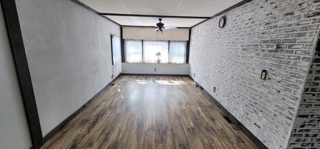 25 Windswept Road Wareham, MA 02571 - Photo 21 of 39 a view of a hallway with wooden floor and a ceiling fan
