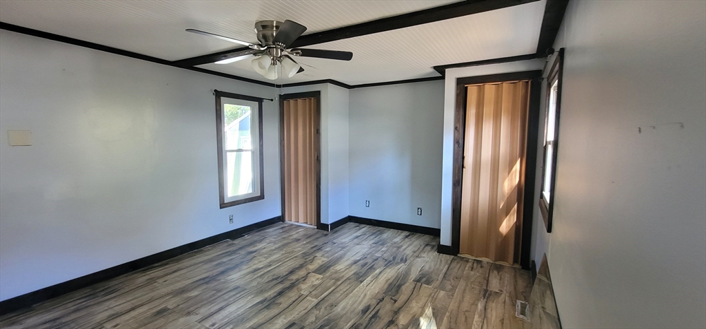 25 Windswept Road Wareham, MA 02571 - Photo 31 of 39 an empty room with wooden floor fan and windows