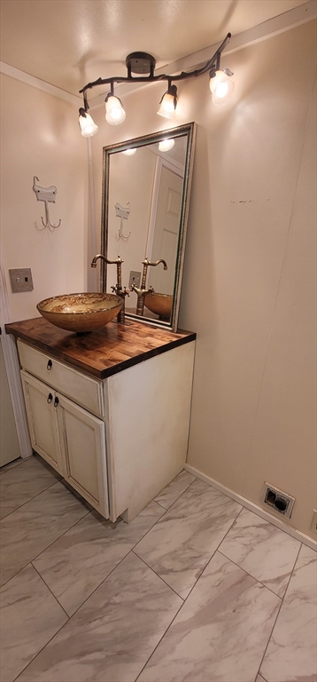 25 Windswept Road Wareham, MA 02571 - Photo 38 of 39 a bathroom with a sink and mirror