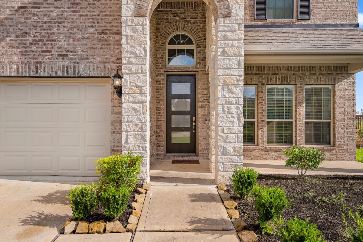 1702 Darwin Cedar Drive Rosharon, TX 77583 - Photo 10 of 44 The modern design starts from the front of the home with an oversized glass door!