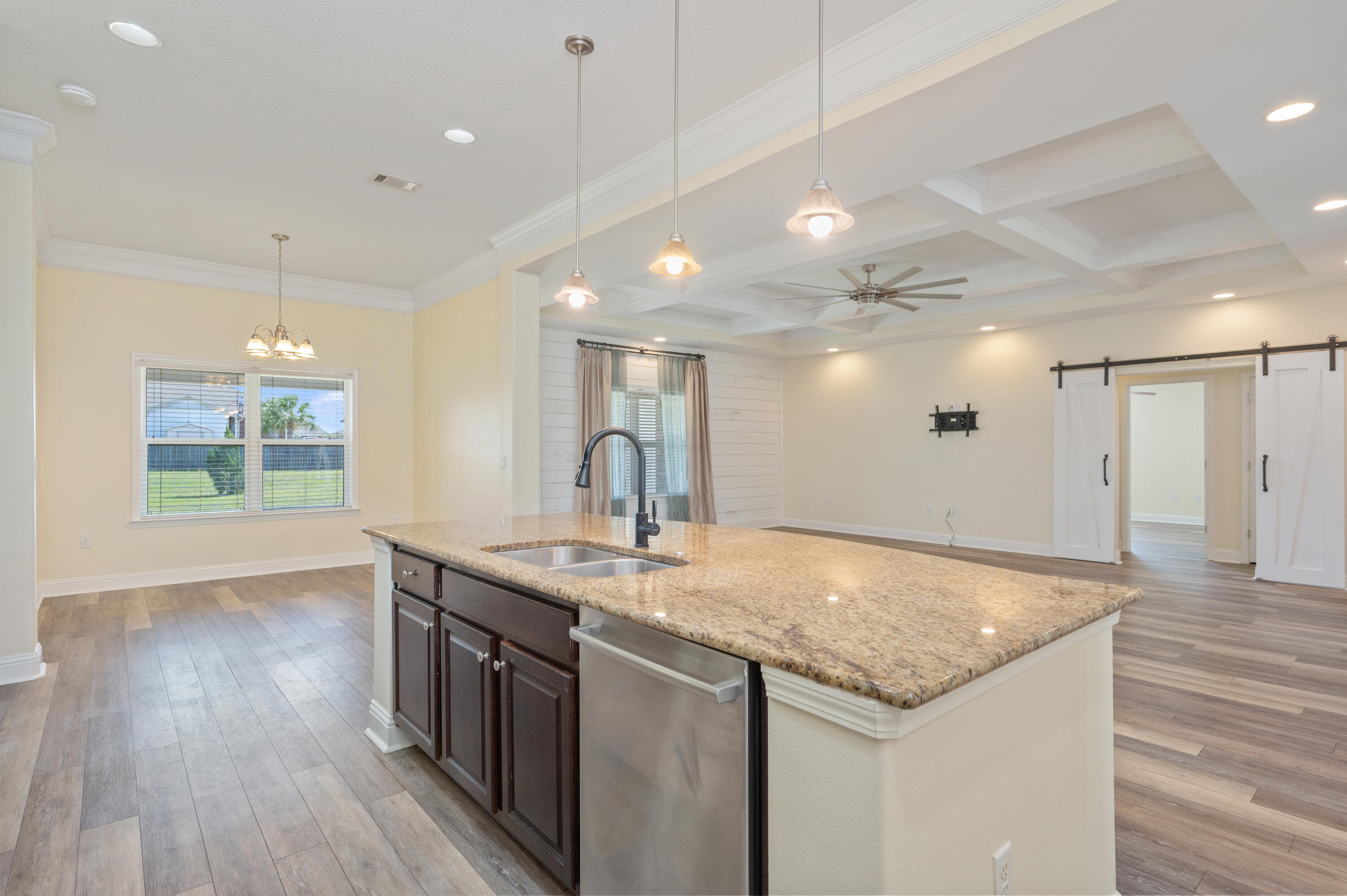 3361 Citrine Circle Crestview, FL 32539 - Photo 13 of 34 a kitchen with center island wooden floor and a refrigerator
