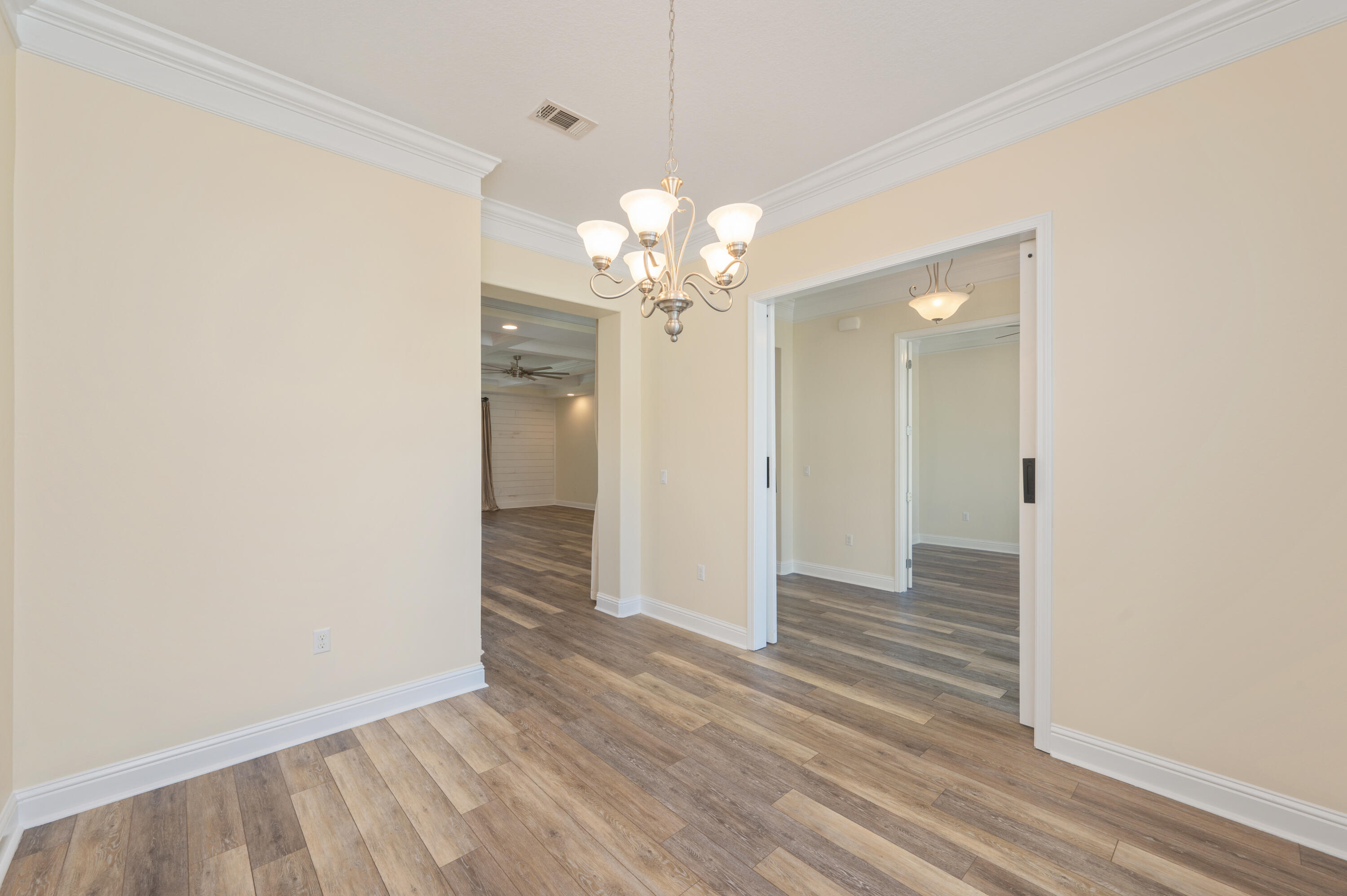 3361 Citrine Circle Crestview, FL 32539 - Photo 14 of 34 a view of a chandelier in big room with wooden floor