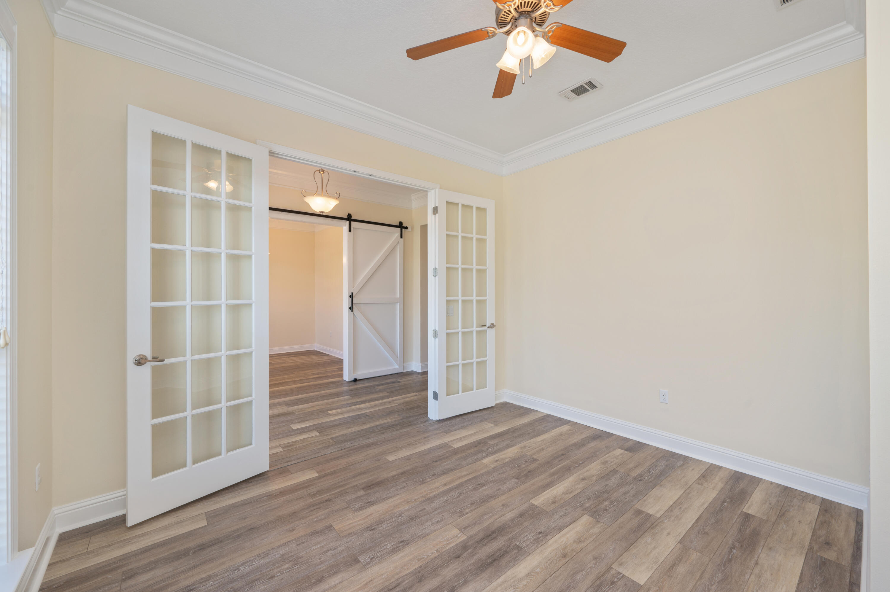 3361 Citrine Circle Crestview, FL 32539 - Photo 16 of 34 wooden floor in an empty room with a window