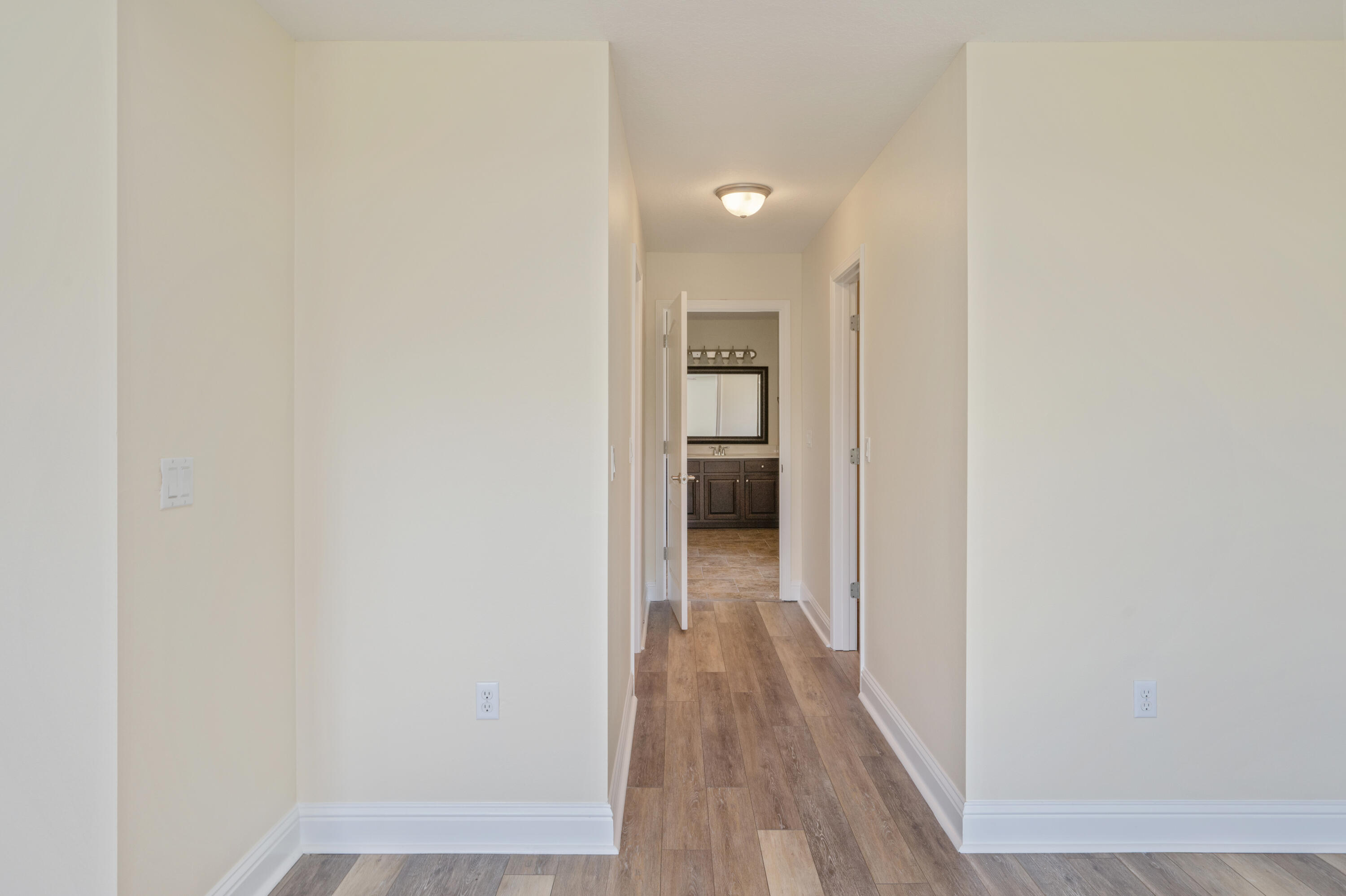 3361 Citrine Circle Crestview, FL 32539 - Photo 20 of 34 a view of a hallway with wooden floor