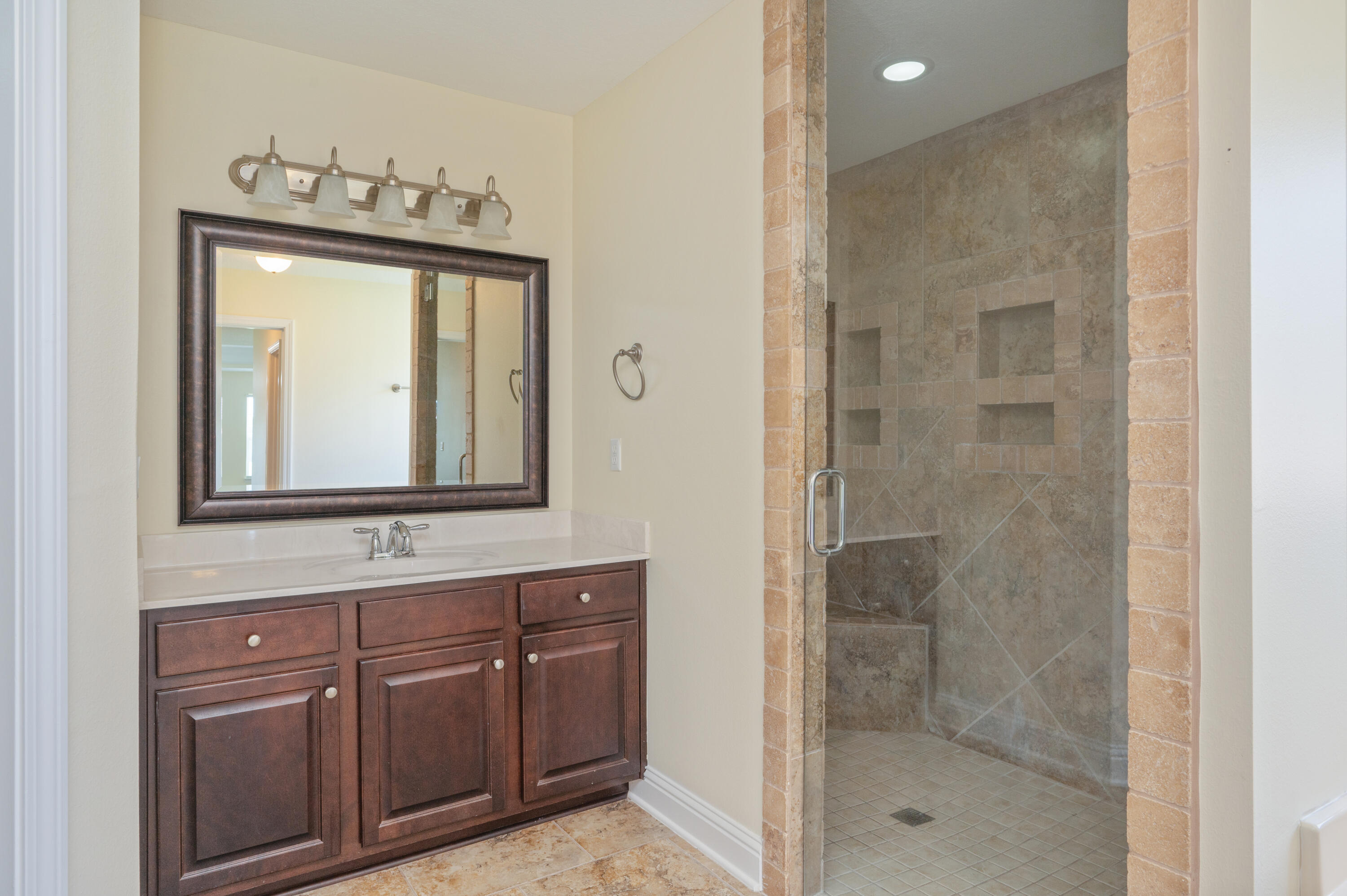 3361 Citrine Circle Crestview, FL 32539 - Photo 21 of 34 a bathroom with a sink a mirror and shower