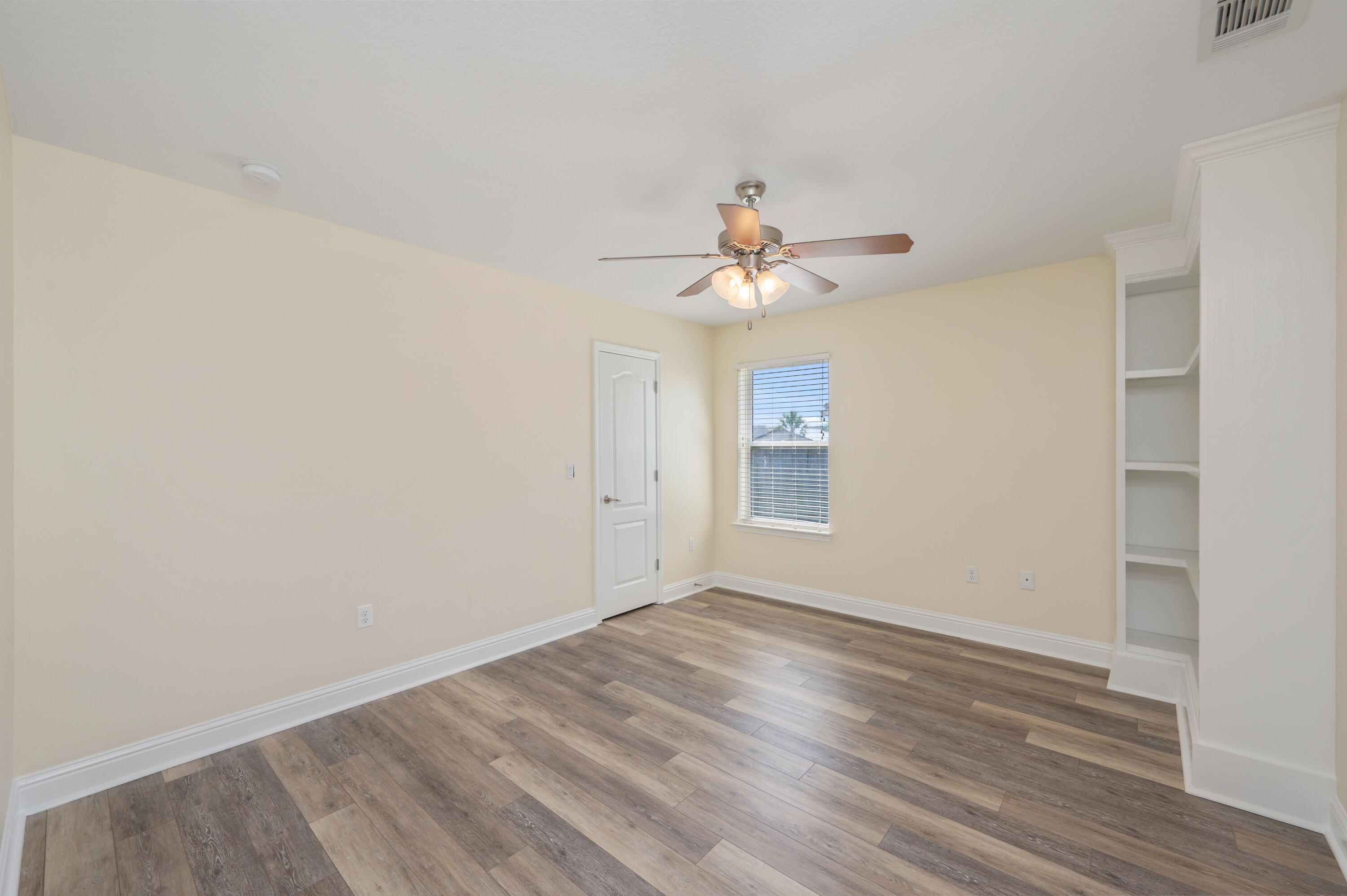 3361 Citrine Circle Crestview, FL 32539 - Photo 26 of 34 a view of an empty room with wooden floor