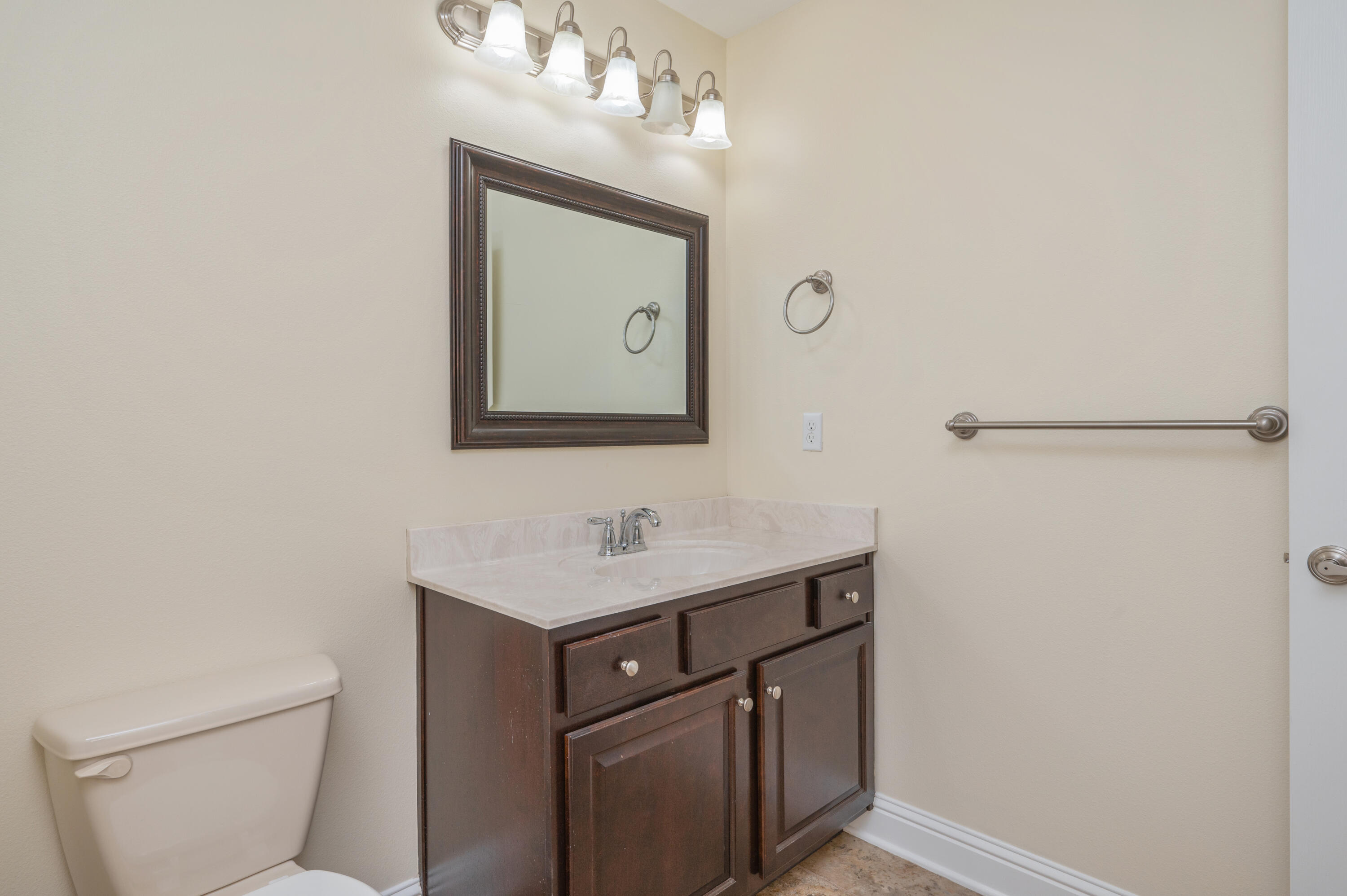 3361 Citrine Circle Crestview, FL 32539 - Photo 30 of 34 a bathroom with a toilet sink vanity and mirror