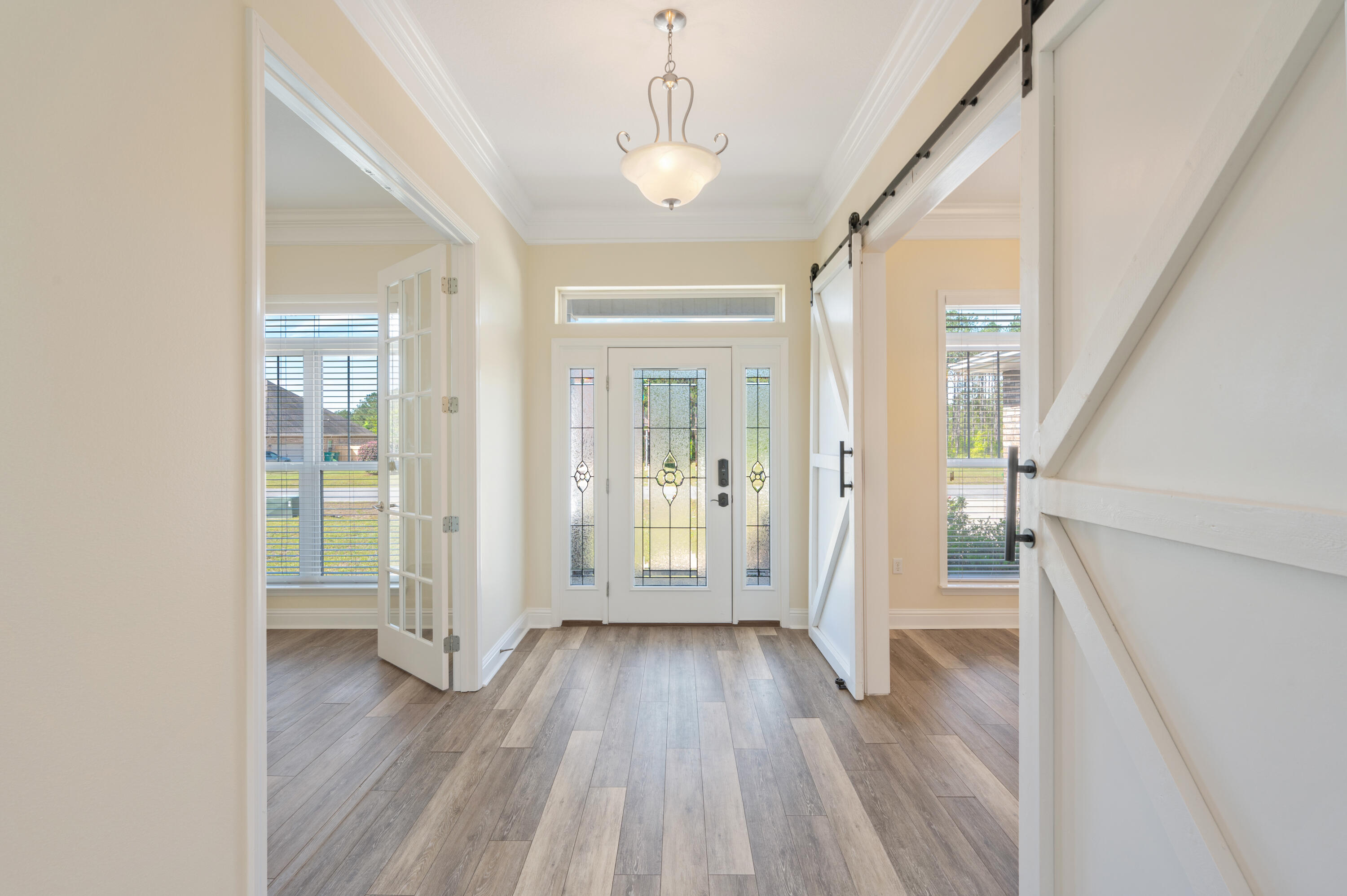 3361 Citrine Circle Crestview, FL 32539 - Photo 4 of 34 a view of a hallway with wooden floor and staircase
