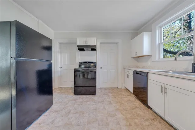 a kitchen with a refrigerator and a sink