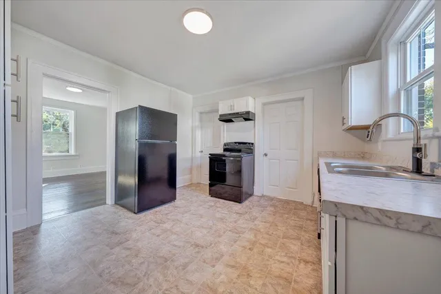 a kitchen with a refrigerator and a sink