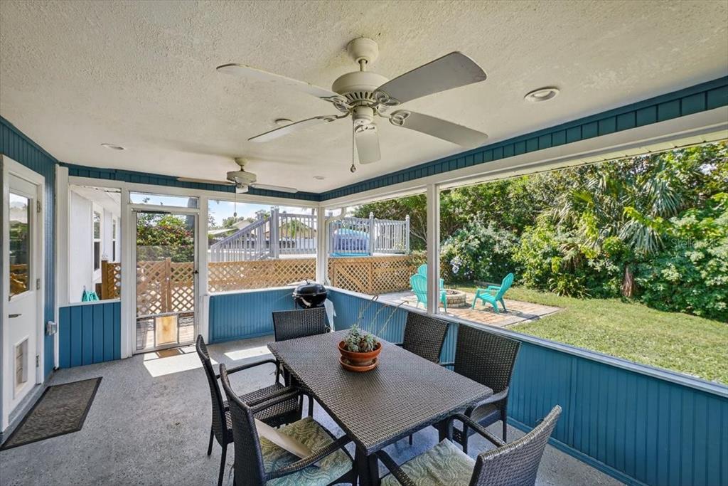 24 Heather Lane Ormond Beach, FL 32174 - Photo 11 of 50 a dining room with furniture large windows and a chandelier