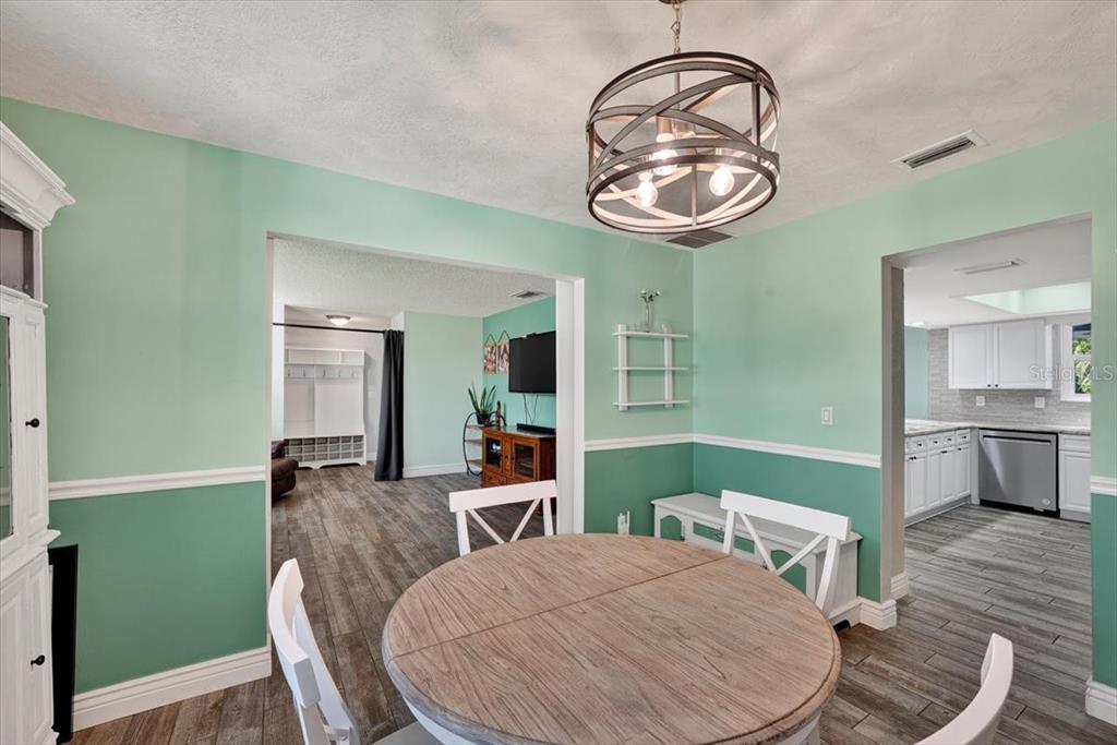 24 Heather Lane Ormond Beach, FL 32174 - Photo 18 of 50 a view of a dining room with furniture and wooden floor