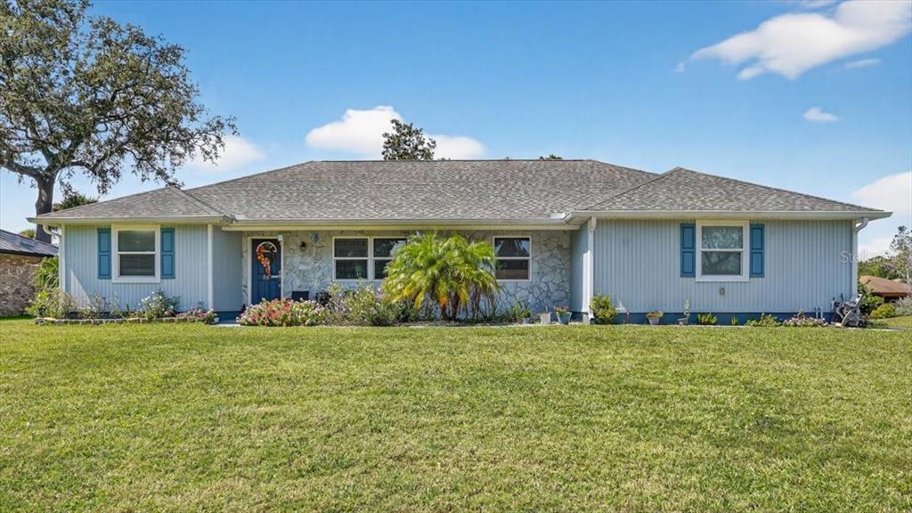24 Heather Lane Ormond Beach, FL 32174 - Photo 2 of 50 a front view of a house with a garden