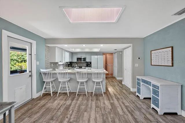 a dining room with a table chairs and a wooden floor