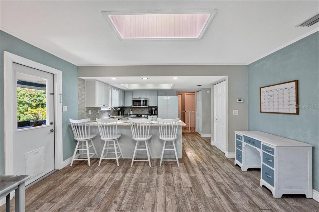 24 Heather Lane Ormond Beach, FL 32174 - Photo 22 of 50 a dining room with a table chairs and a wooden floor