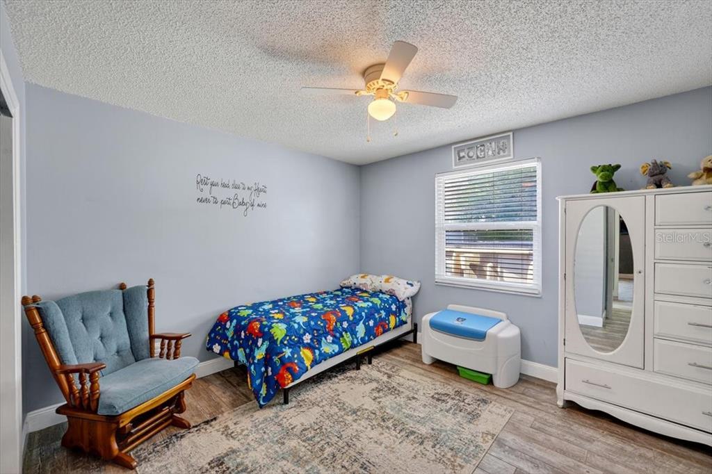 24 Heather Lane Ormond Beach, FL 32174 - Photo 28 of 50 a bedroom with a bed and a chandelier