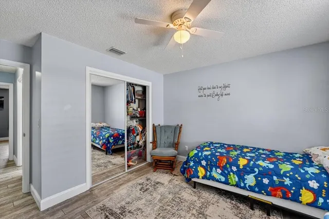 a bedroom with a bed a couch and dresser