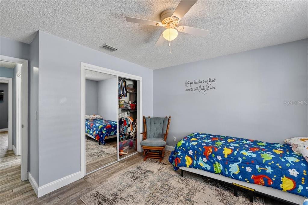 24 Heather Lane Ormond Beach, FL 32174 - Photo 29 of 50 a bedroom with a bed a couch and dresser