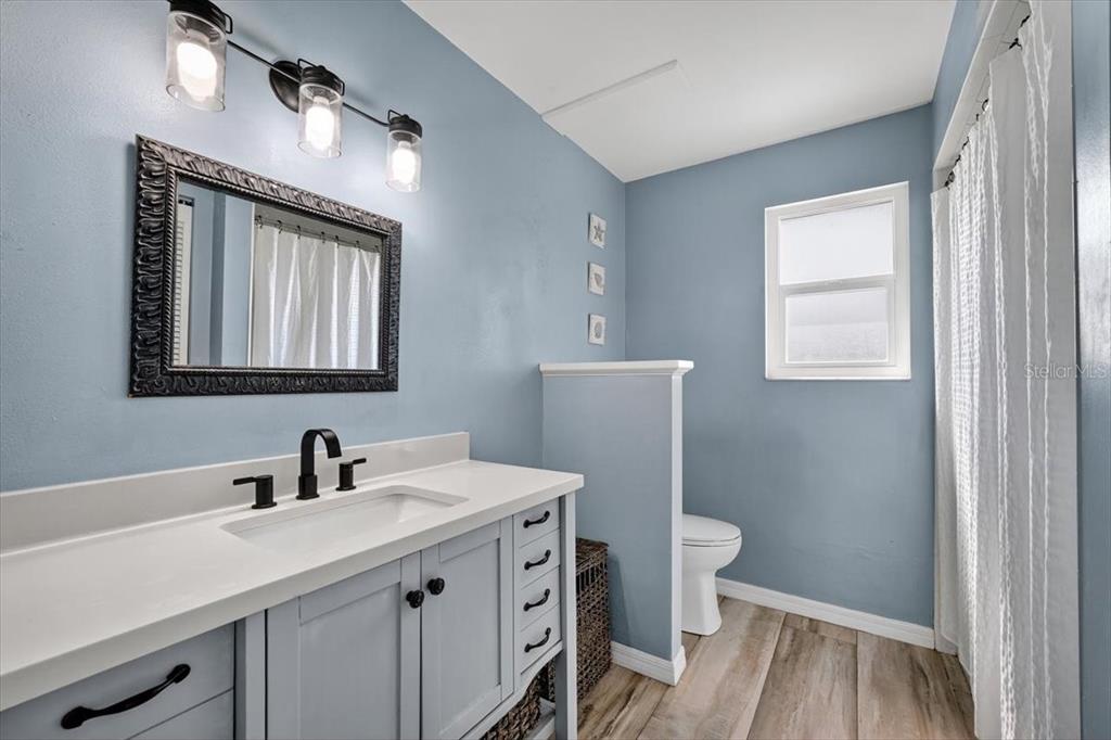 24 Heather Lane Ormond Beach, FL 32174 - Photo 30 of 50 a bathroom with a sink a toilet and a mirror