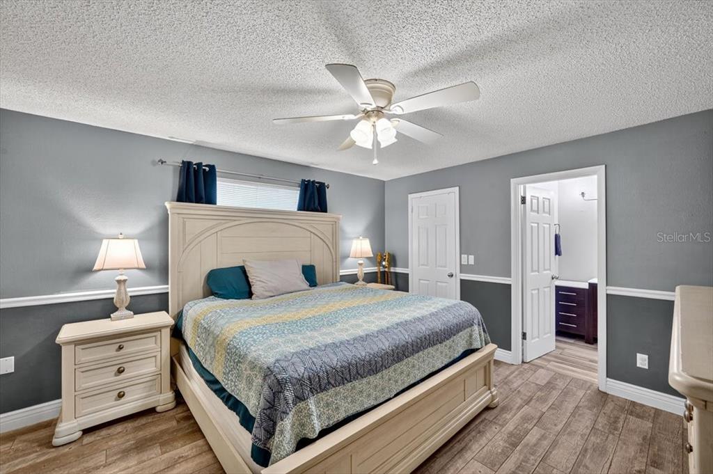 24 Heather Lane Ormond Beach, FL 32174 - Photo 32 of 50 a bedroom with a bed and a chandelier