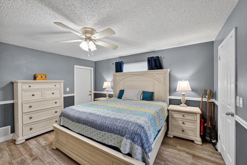 24 Heather Lane Ormond Beach, FL 32174 - Photo 33 of 50 a bedroom with a bed and a chandelier