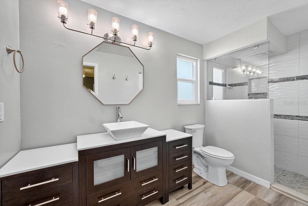 24 Heather Lane Ormond Beach, FL 32174 - Photo 34 of 50 a bathroom with a sink a toilet a mirror and shower