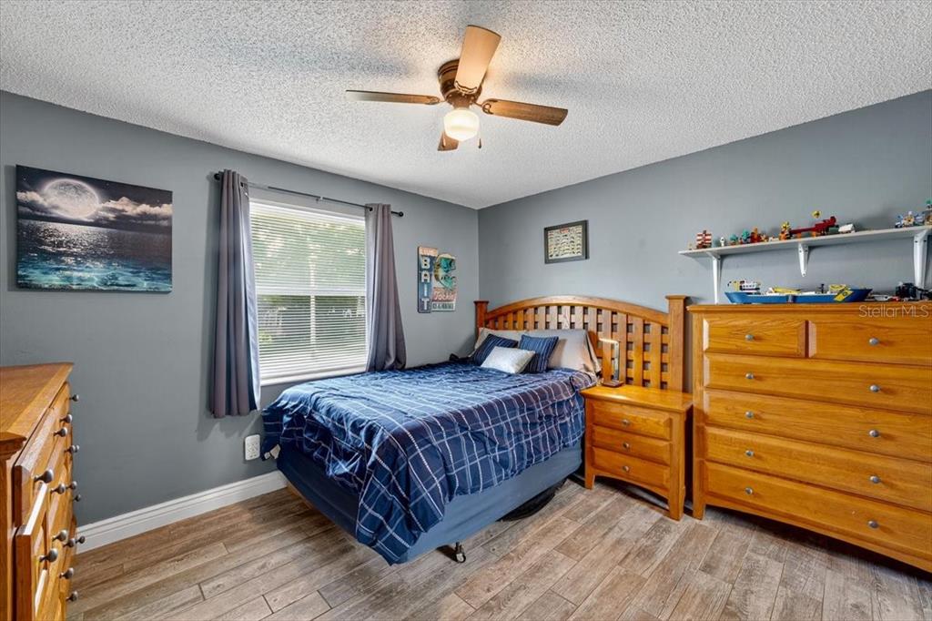 24 Heather Lane Ormond Beach, FL 32174 - Photo 36 of 50 a bedroom with a bed and a chandelier