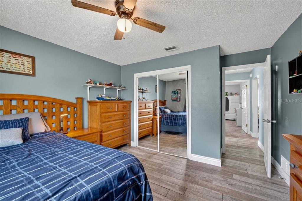 24 Heather Lane Ormond Beach, FL 32174 - Photo 37 of 50 a bedroom with a bed and a chandelier