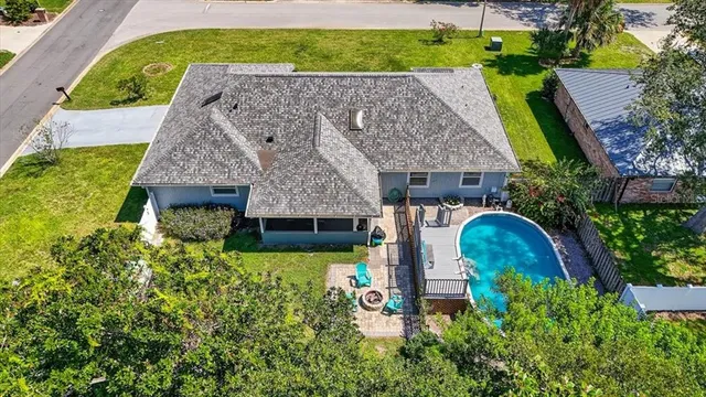 an aerial view of a house with swimming pool garden and patio