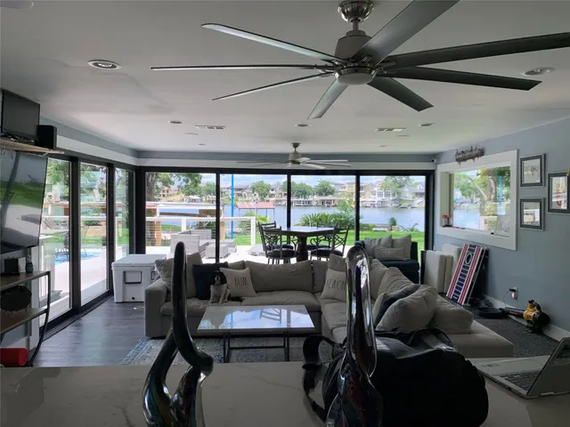 a living room with furniture and a floor to ceiling window