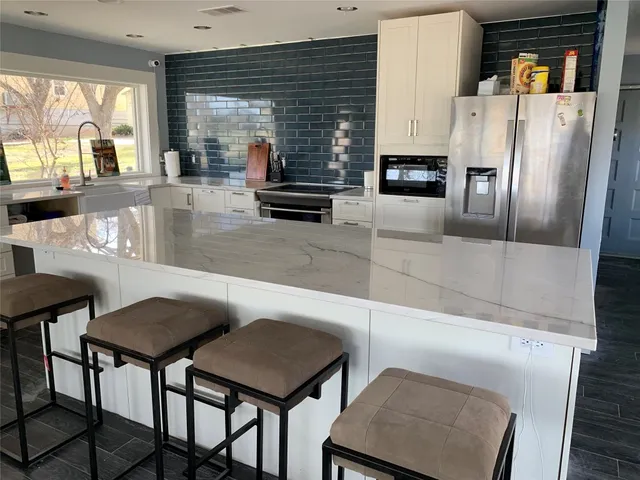 a dining room with furniture and large windows