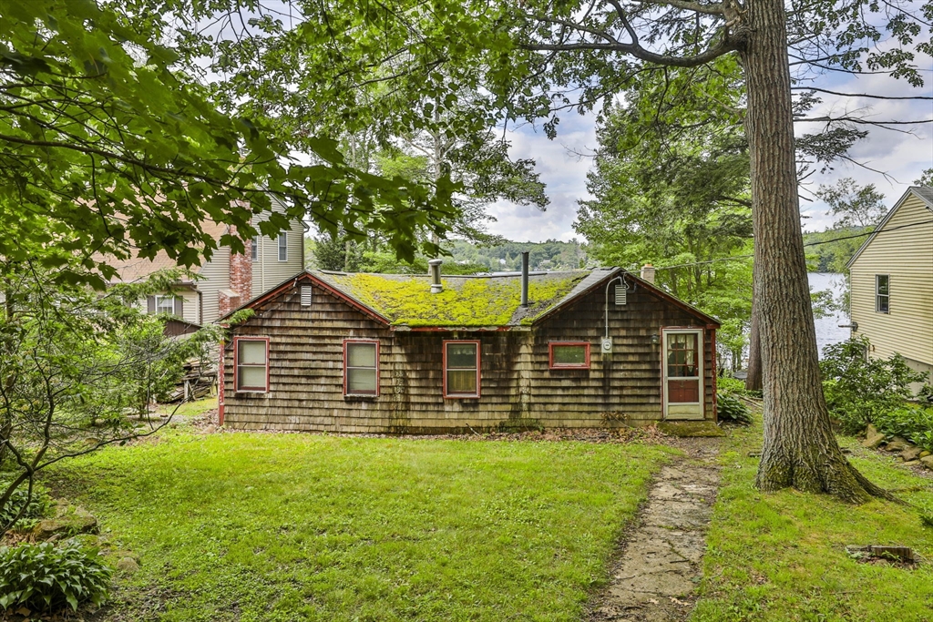 a front view of a house with a garden and yard