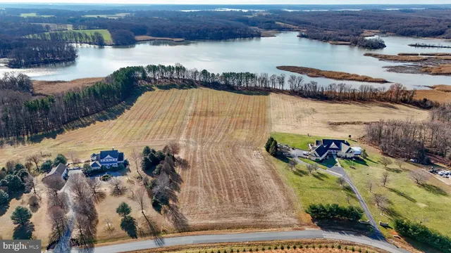 an aerial view of a house with outdoor space and lake view