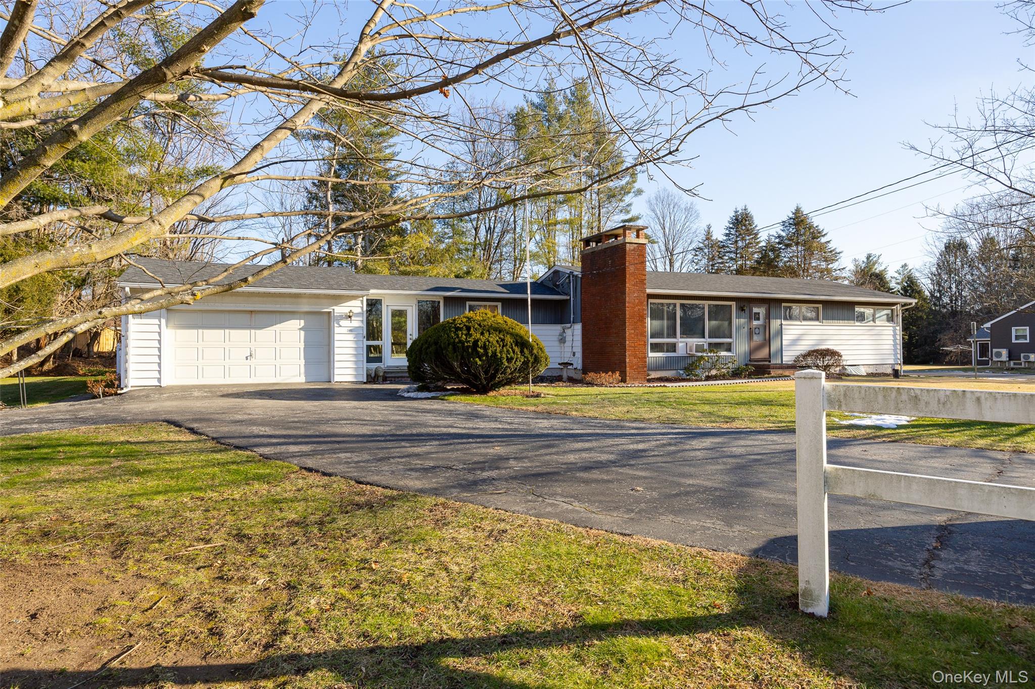 a view of a white house with a swimming pool