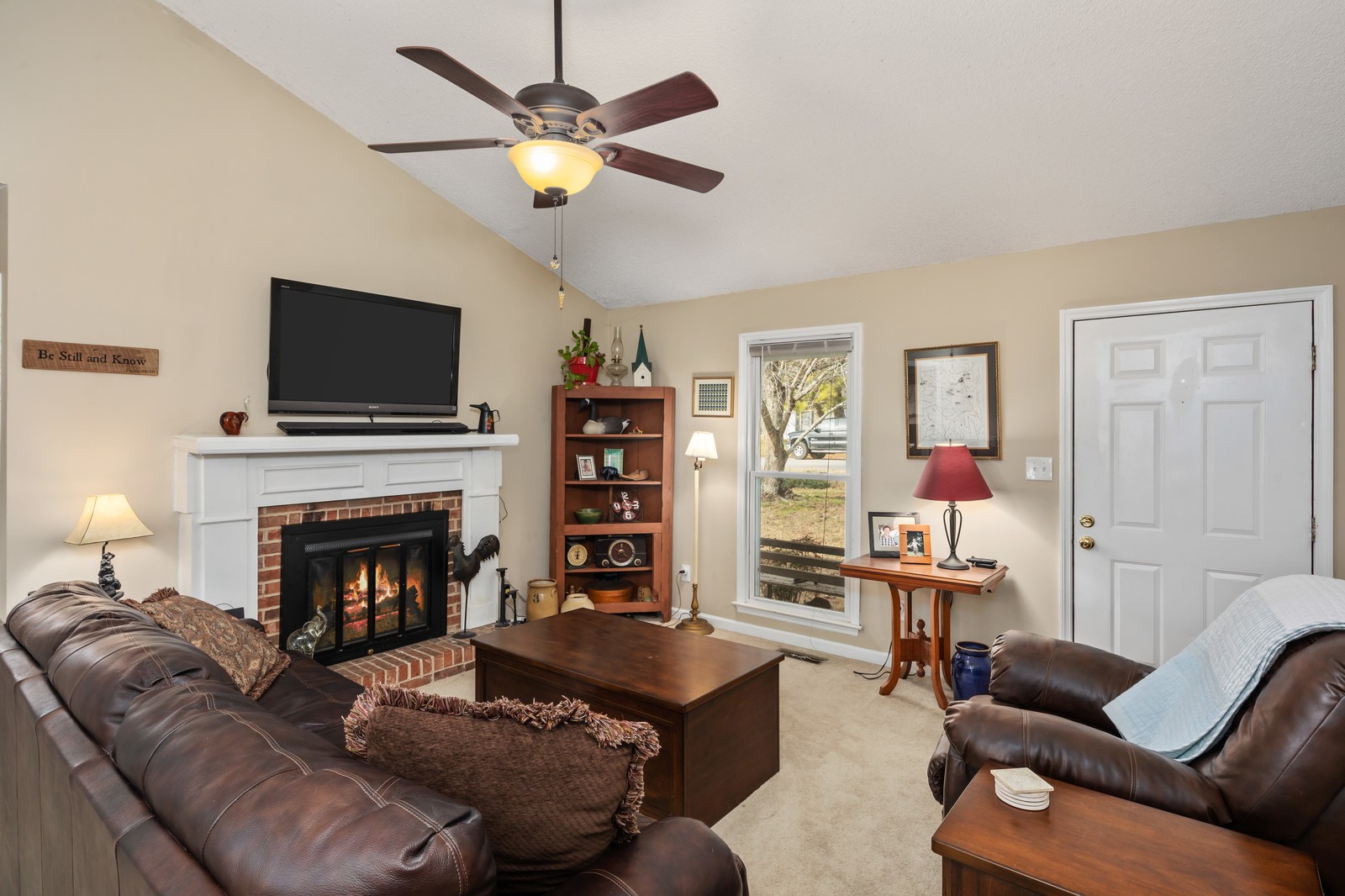 704 Riverview Drive Franklin, TN 37064 - Photo 6 of 33 a living room with furniture a flat screen tv and a fireplace