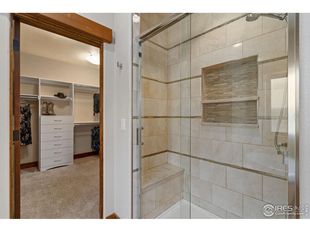 6611 Murano Drive Windsor, CO 80550 - Photo 13 of 35 a bathroom with a shower and a glass door