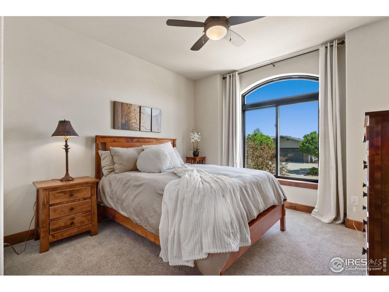 6611 Murano Drive Windsor, CO 80550 - Photo 16 of 35 a bed sitting in a bedroom next to a window