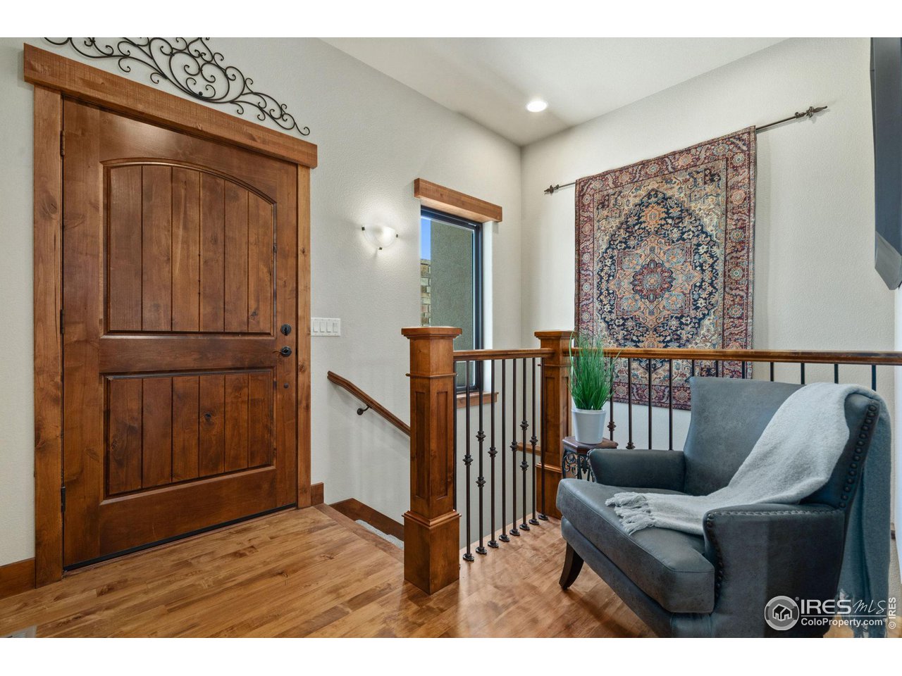6611 Murano Drive Windsor, CO 80550 - Photo 27 of 35 a view of a hallway with wooden floor and windows