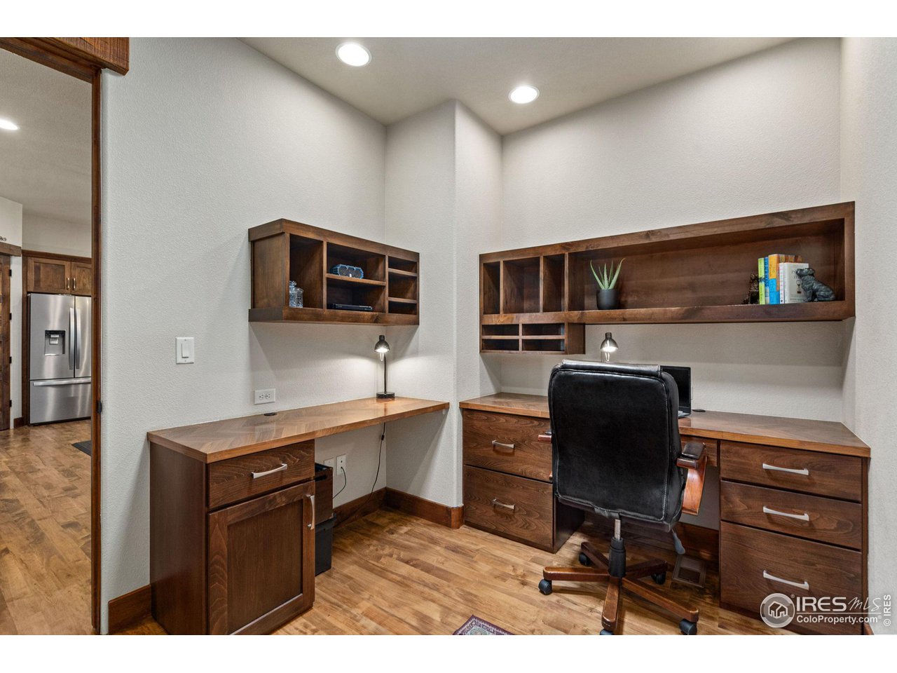 6611 Murano Drive Windsor, CO 80550 - Photo 8 of 35 a kitchen with stainless steel appliances kitchen island granite countertop a stove a sink and a microwave
