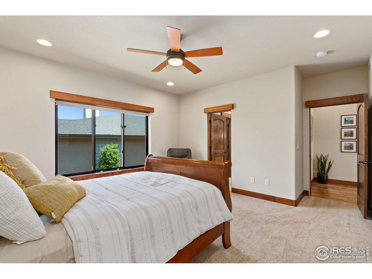6611 Murano Drive Windsor, CO 80550 - Photo 10 of 35 a bedroom with a large bed and a large window