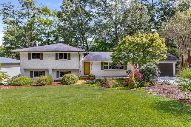 a front view of a house with garden