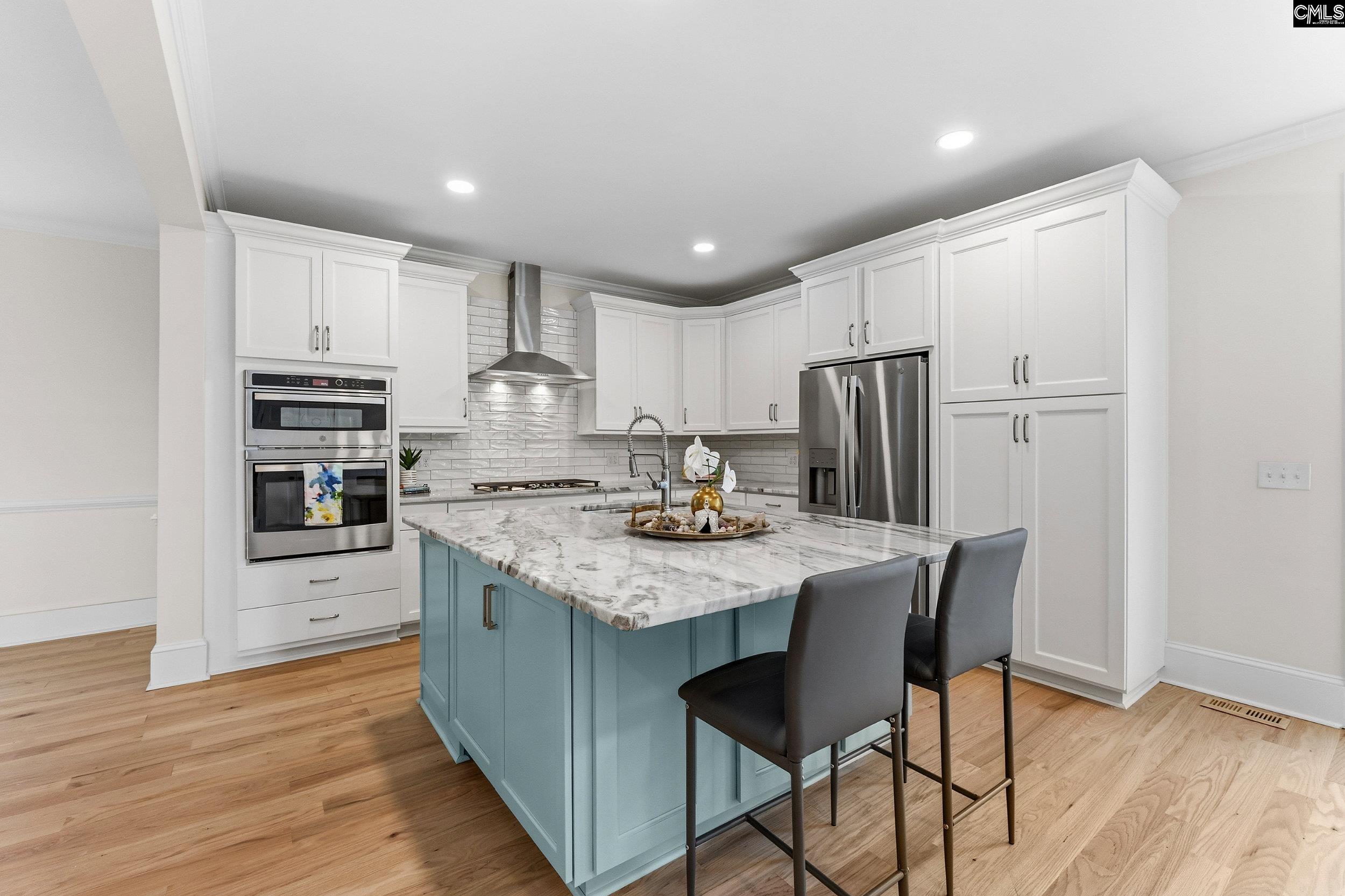 121 Silver Lake Road East Columbia, SC 29223 - Photo 13 of 57 a kitchen with stainless steel appliances granite countertop a stove refrigerator a oven a sink with a dining table and chairs