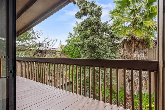 a view of balcony with wooden floor