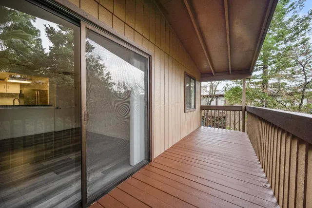 a view of a balcony with wooden floor