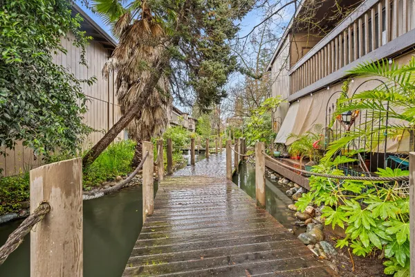 a wooden bridge with trees in front of it
