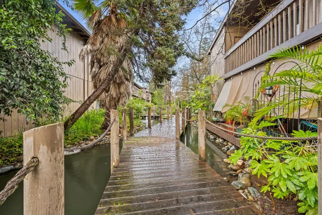 a wooden bridge with trees in front of it
